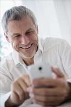 Older Caucasian man using cell phone