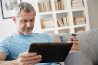 Older Caucasian man online shopping with digital tablet