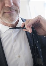 Older Caucasian businessman loosening tie