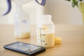 Cell phone near bottle of breast milk