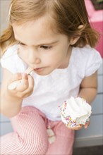 Caucasian girl eating ice cream with spoon