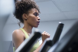 Black woman running on treadmill