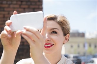 Caucasian woman posing for cell phone selfie