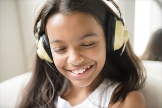 Mixed Race girl listening to headphones