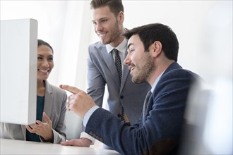 Smiling business people talking in office