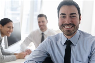 Portrait of smiling businessman in office