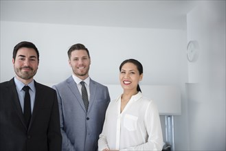 Smiling business people posing in office