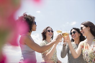 Women drinking wine outdoors