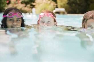 Surface level view of faces of girls in swimming pool