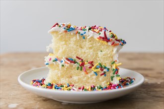 Slice of cake with sprinkles on plate