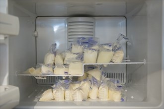 Bags of frozen breast milk in freezer