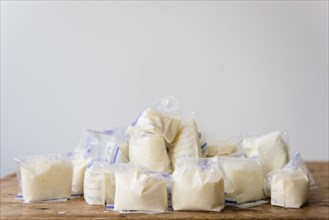 Bags of frozen breast milk on table