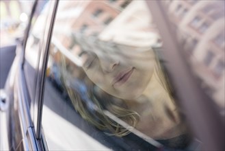 Caucasian woman relaxing in car