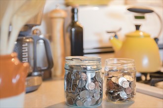Jars of coins on kitchen counter