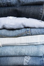 Stack of folded blue jeans