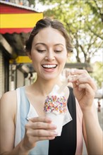 Thai woman eating ice cream in city