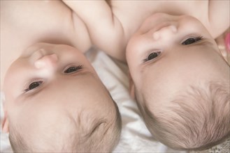 Faces of Caucasian twin baby girls