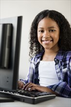 Mixed Race girl using computer