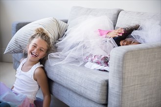 Laughing girls playing on sofa