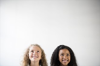 Faces of smiling girls looking up