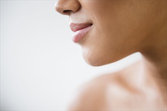 Close up of mouth of Mixed Race woman with bare shoulders