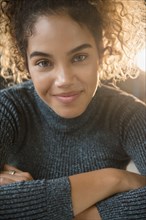 Smiling Mixed Race woman wearing sweater