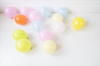 Multicolor balloons on white floor