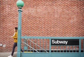 Mixed Race woman exiting subway station in city