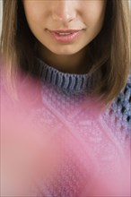 Lips of Mixed Race woman wearing blue sweater