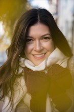 Smiling Caucasian woman wearing gloves and scarf