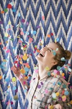 Happy woman celebrating with confetti