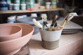 Pottery brushes and bowls in workshop