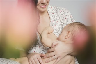 Caucasian mother breastfeeding baby son