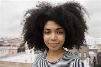 Smiling African American woman posing on rooftop
