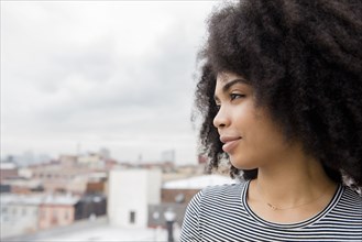 African American woman smiling on rooftop