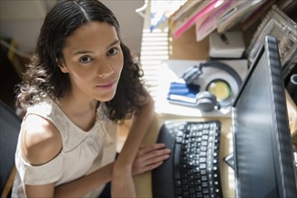 Portrait of Hispanic woman using computer