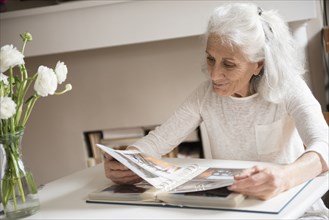 Older woman enjoying photo album