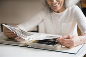 Older woman enjoying a photo album