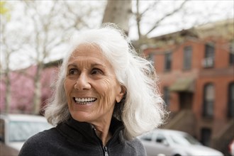 Smiling older woman outdoors in city