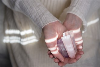 Hands of Caucasian woman holding crystals