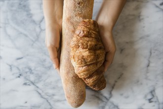 Hands of African American woman holding bread