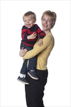 Caucasian mother holding son