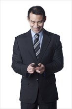 Chinese businessman text messaging on cell phone