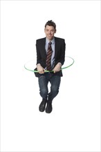 Caucasian businessman jumping plastic hoop