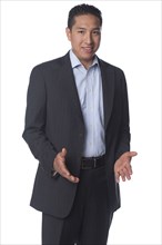 Smiling Hispanic businessman gesturing