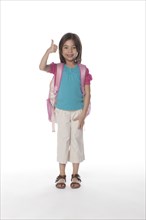 Mixed race girl giving a thumb's up carrying backpack