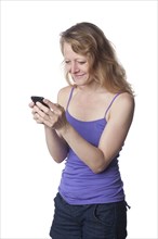 Caucasian woman text messaging on cell phone