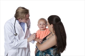 Caucasian doctor examining baby boy