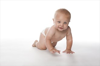 Caucasian baby boy crawling