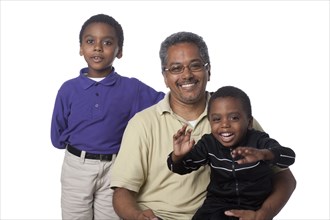 Hispanic father and sons standing together